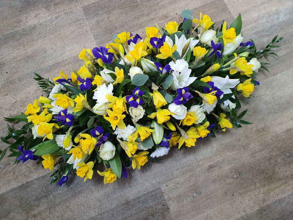 casket spray with added spring flowers
