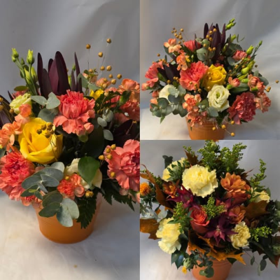 autumnal round pot arr - round arrangement in a pot usually in shades of orange, yellow, bronze but may also use red or cream etc