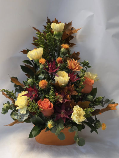 front facing autumn arrangement - generally orange, yellow, bronze, red etc front facing arrangement in a container