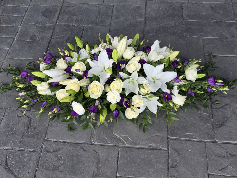purple and white casket spray