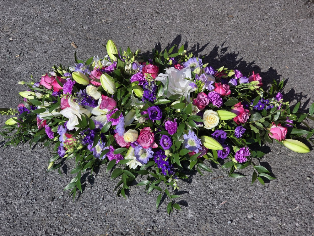fuller casket spray in white, mauve and purple