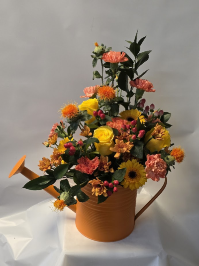 mixed  autumn watering can - Brighten someone's day with this vibrant bouquet from Six Ways Florist, Llanelli. Bursting with sunny yellows and warm oranges, this lively arrangement is perfect for birthdays, celebrations, or simply sharing joy.