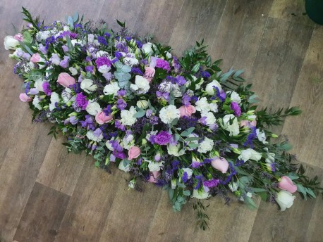 large purple white and pink casket spray